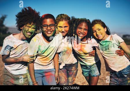 Gli amici riempiono la vostra vita di colore. Girato di un gruppo di adolescenti che si divertono con la polvere colorata al campo estivo. Foto Stock