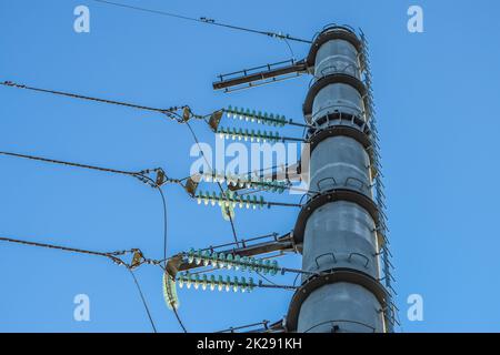 Supporta le linee elettriche ad alta tensione contro il cielo blu Foto Stock