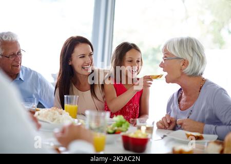 Il cibo ha un sapore migliore quando lo mangiate con la famiglia. Shot di una felice famiglia multi-generazionale che ha un pasto insieme. Foto Stock