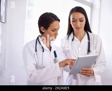 È più facile se si va in questo modo. Scatto di un giovane medico che riceve consigli da un collega. Foto Stock