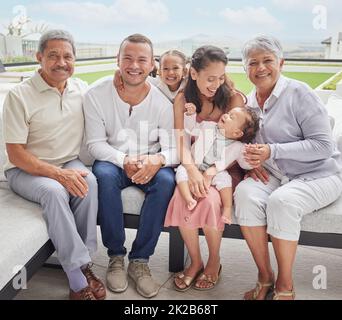 Famiglia, genitori e nonni felici in giardino a casa e bambini con madre, papà e nonna e nonno con sorriso in estate. Ritratto del volto di Foto Stock