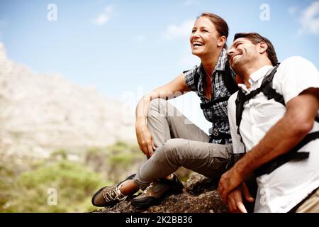 Romanticismo nella natura. Due escursionisti ridono e sorridono mentre si gode di una vista sulla cima della montagna. Foto Stock