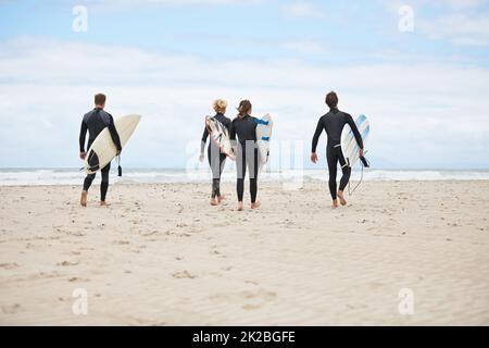 Il surf non è più rinvigorente. I giovani surfisti sono entusiasti di colpire le onde impressionanti. Foto Stock