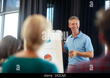 Senza di voi non sarebbe possibile. Scatto di un uomo maturo che fa una presentazione per i suoi colleghi. Foto Stock