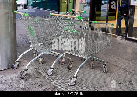 I carrelli vuoti della drogheria si trovano di fronte all'ingresso del centro commerciale Foto Stock