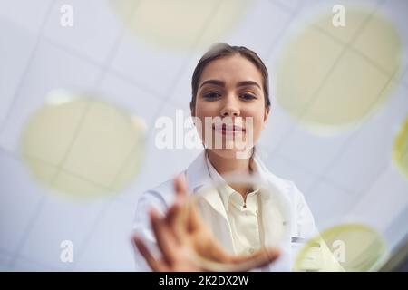 Scoprire le prossime grandi innovazioni nella scienza. Inquadratura a basso angolo di un giovane scienziato che conduce un esperimento in un laboratorio. Foto Stock