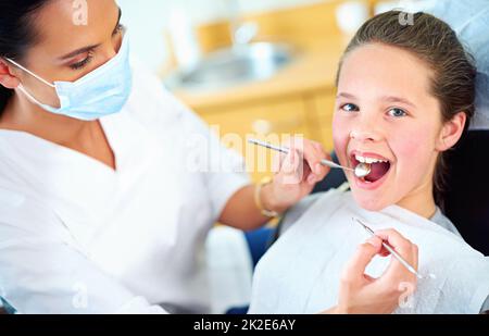 Nessun problema per questo controllo. Ritratto di una giovane ragazza ha un controllo al dentista. Foto Stock