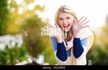 Sorpresa. Ritratto corto di una giovane donna che gesta eccitati all'aperto. Foto Stock