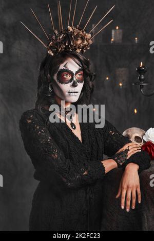 È più di una tradizione. Scatto corto di una giovane donna attraente vestito con il suo costume messicano di Halloween. Foto Stock