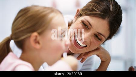 Assicurandosi che il suo sorriso sia luminoso quanto il suo futuro. Scatto di una bella madre giovane che guarda sua figlia spazzolare i denti nel bagno a casa. Foto Stock