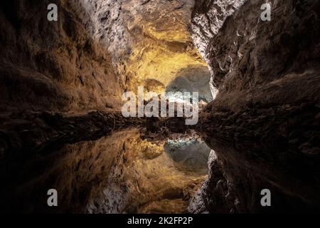 Illusione ottica - riflessione dell'acqua in Cueva de los Verdes, un incredibile tubo di lava e attrazione turistica sull'isola di Lanzarote, in Spagna Foto Stock