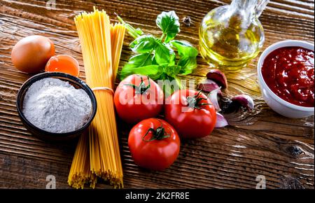 Composizione con spaghetti secchi e ingredienti di pasta Foto Stock