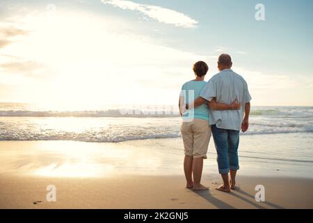 La vita è piena di bellezza. Notatelo. Foto retrostensiva di una coppia che ammirava la vista mentre si trova in spiaggia. Foto Stock