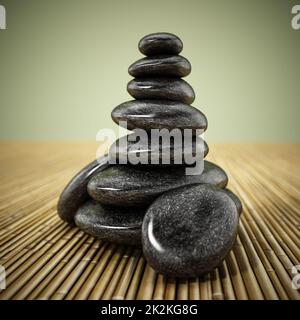 Pietre equilibranti nere in piedi su sfondo di bambù. Illustrazione 3D Foto Stock