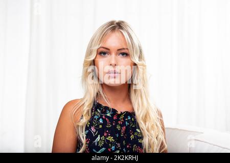 giovane donna bionda con linee mascherate di abbronzatura sul viso Foto Stock