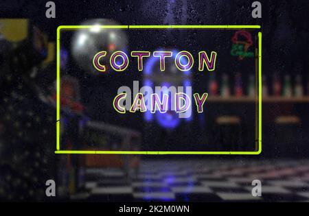 Vintage Neon Cotton Candy Sign in Rainy Window Foto Stock