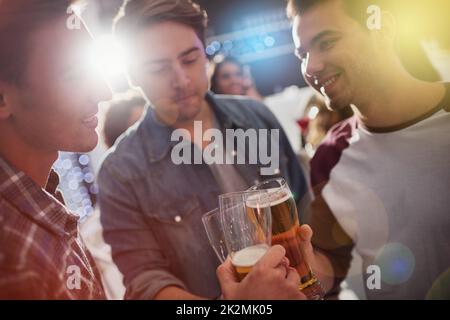 Grazie ragazzi. Un'immagine di ragazzi che tostano con le birre durante una festa. Foto Stock