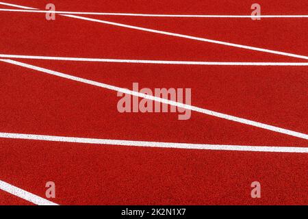 Linee bianche rosse della traccia in corso Foto Stock