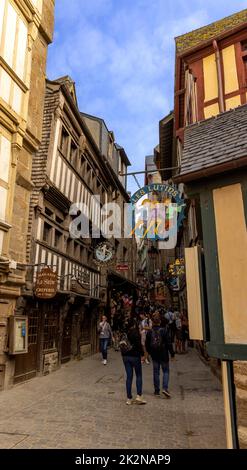 I turisti che visitano i vicoli medievali di le Mont Saint-Michel o il Monte di San Michele, Avranches, Normandia, Francia. Foto Stock