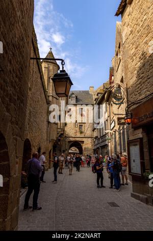 I turisti che visitano i vicoli medievali di le Mont Saint-Michel o il Monte di San Michele, Avranches, Normandia, Francia. Foto Stock