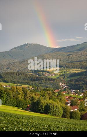 Lam, una piccola città della Baviera in estate dopo una tempesta con un arcobaleno. Vista sul monte GroÃŸer Arber con le sue due torri Baviera, Germania. Foto Stock