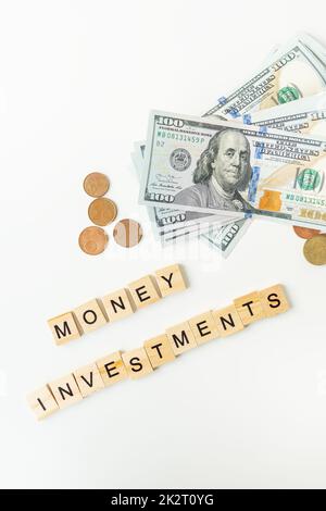 Moneta internazionale, inclusi euro, dollaro, moneta, dollaro. L'iscrizione in lettere di legno investimenti di denaro. Foto Stock