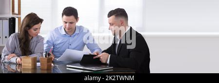 Advisor discutendo con coppia Foto Stock