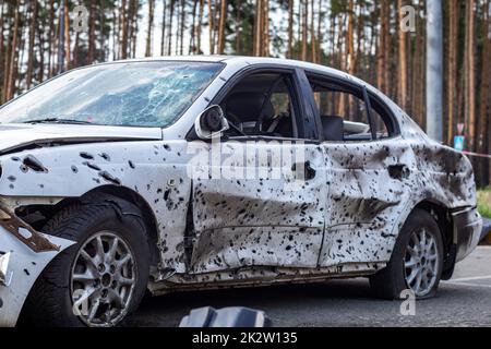 Fucilato, auto danneggiate durante la guerra in Ucraina. Il veicolo di civili colpiti dalle mani dell'esercito russo. Buchi di proiettile e di shrapnel nel corpo della vettura. Guerra della Russia contro l'Ucraina. Foto Stock