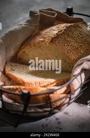 Pane, grano e segale tradizionale pane di pasta madre tagliato a fette in un cestino, primo piano. Messa a fuoco selettiva Foto Stock