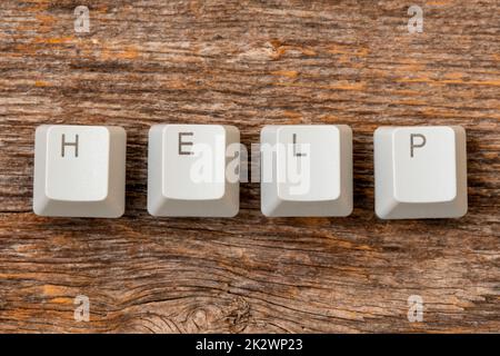 Quattro tasti della tastiera del computer disposti per scrivere LA PAROLA DI AIUTO Foto Stock
