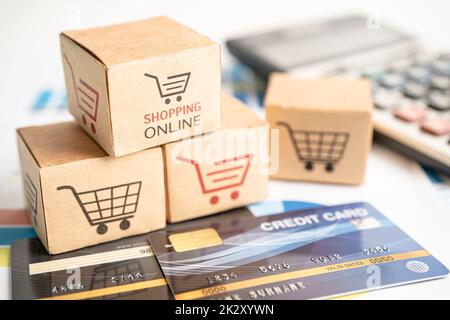 Shopping online box con carta di credito e calcolatrice sul grafico. Finanza commercio importazione esportazione concetto di business. Foto Stock