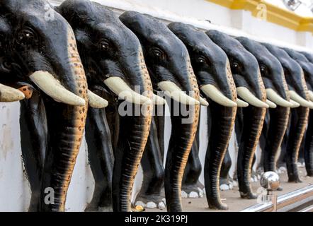 Una fila di statue di elefanti sulla parete esterna che circonda il Ruhunu Maha Kataragama Dewalaya (Tempio Kataragama) a Kataragama in Sri Lanka. Foto Stock