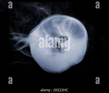 Anello di fumo su sfondo nero Foto Stock