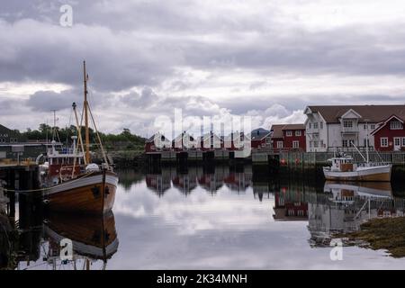Svolvaer, Norvegia - 17 luglio 2022: Svolvaer Promenade. Barche bianche e gialle. Case bianche e rosse in una nuvolosa giornata estiva. Messa a fuoco selettiva Foto Stock