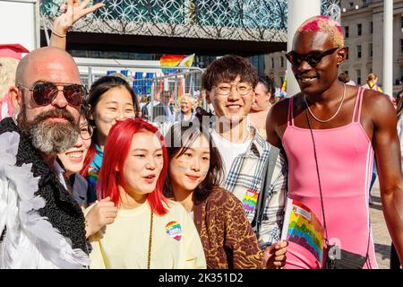 Posa barbuto uomo, asiatici e uomo con pelle nera indossando il leotard rosa al Gay Pride parata protesta 2022 nel centro di birmingham uk settembre 24th Foto Stock