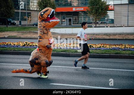 Kazakistan, Almaty-25 settembre 2022: Maratona di Almaty. La gente corre lungo un ampio viale Foto Stock