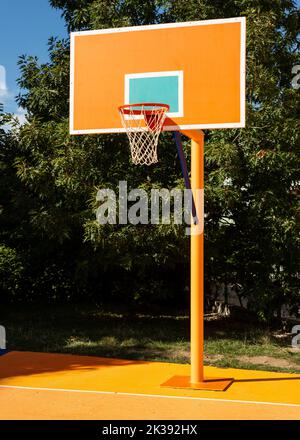 Campo da basket arancione sul colorato campo da basket all'aperto. Foto Stock