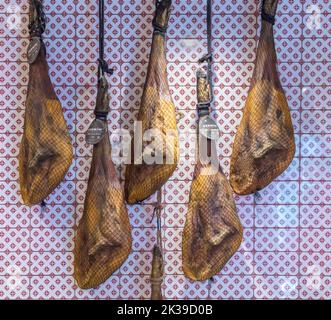 Gambe di prosciutto iberico appese Foto Stock