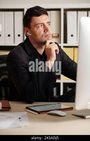 Ritratto dell'imprenditore penoso che medita sullo sviluppo del business Foto Stock