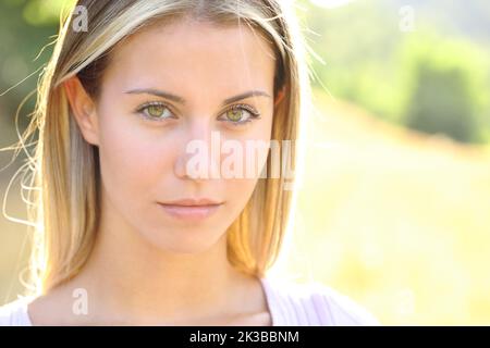 Ritratto di una bella giovane donna che guarda la macchina fotografica in montagna Foto Stock