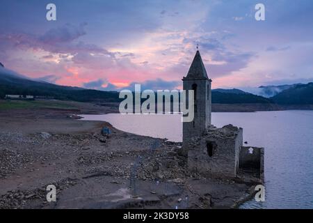 Campanile di Sau completamente esposto durante la siccità del 2022. Alba rossa nella palude (Osona, Barcellona, Catalogna, Spagna) ESP: Campanario de Sau Foto Stock