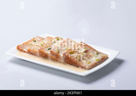 Delizioso e cremoso Shahi Tukrey (budino di pane). Shahi Tukda tukra immerso in Rabri o doppia ka meetha diwali dolce fatto con pane Foto Stock