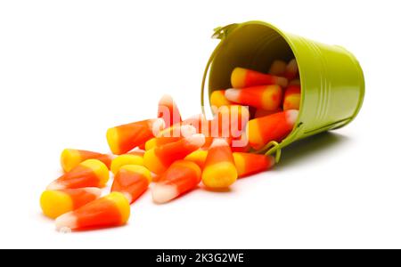 Secchio con corni di caramelle di Halloween su sfondo bianco Foto Stock