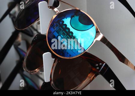 Molti occhiali da sole sulla strada stand a Heidelberg, Germania. Gruppo di occhiali da sole colorati sullo scaffale del negozio ottico. Occhiali, protezione solare Foto Stock