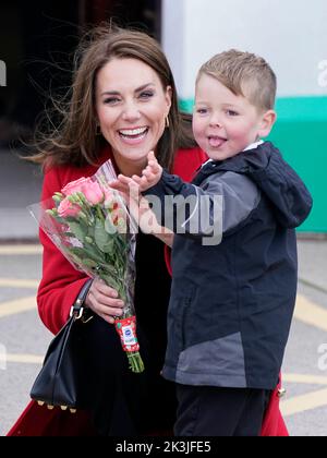 RITRASMETTERE IL NOME AGGIUNTO la principessa del Galles riceve una posy di fiori da Theo Crompton, di quattro anni, mentre arriva per una visita alla stazione di Lifeboat di RNLI Holyhead, a Holyhead, Galles, dove con il Principe del Galles incontrano l'equipaggio, volontari e alcuni di coloro che sono stati sostenuti dalla loro unità locale. Holyhead è una delle tre più antiche stazioni di scialuppa di salvataggio della costa gallese e ha una notevole storia di coraggio, avendo ricevuto 70 premi per la gallantry. Data immagine: Martedì 27 settembre 2022. Foto Stock