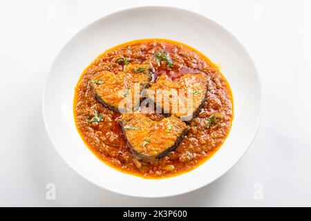Ruhu rui o Katla Fish curry, tradizionale bangali curry di pesce, disposti in una ciotola di ceramica bianca guarnita con fresco rosso freddo e foglie di curry su un Foto Stock