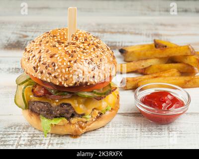 Hamburger gustoso con manzo, pancetta, formaggio, cetriolo, pomodoro Foto Stock