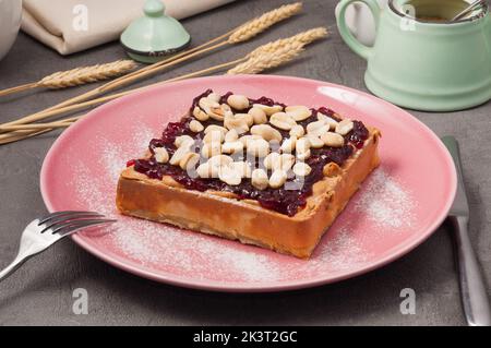 waffle dolci con marmellata e burro di arachidi decorato con arachidi Foto Stock