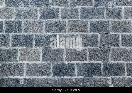 Grigio chiaro, mattoni bianchi sulla decorazione della parete per lo sfondo. Strutture in mattoni di pietra. Foto di alta qualità Foto Stock