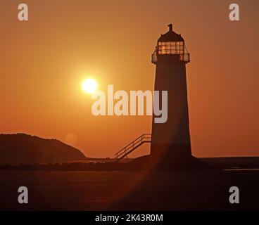 Punto di Ayr Lighthouse, noto anche come Talacre Lighthouse, costa settentrionale del Galles, Regno Unito, CH8 9RD, al tramonto di sera Foto Stock